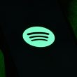 Spotify executives collaborating with major music labels on AI-powered music innovation.