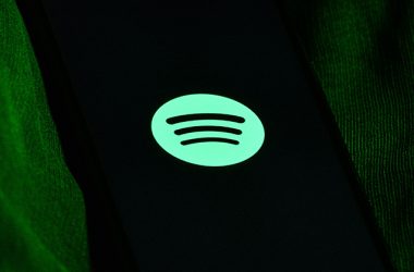 Spotify executives collaborating with major music labels on AI-powered music innovation.
