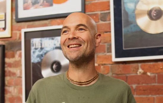 Caleb Williams of Unified Music Group discusses managing kirtan artists and heavy bands, focusing on touring, success metrics, and mental health.